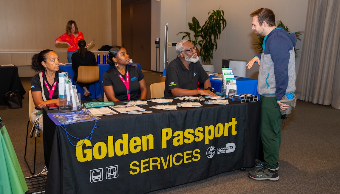 Golden Passport representatives talking with event attendee