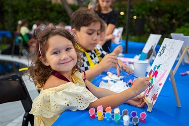 Kid painting at Poetry in the Park